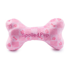 Hueso rosa a cuadros en peluche, textura suave para juego interactivo.