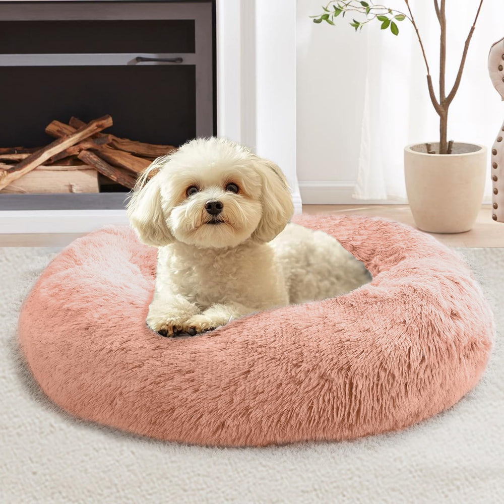 Cama donut JOLLYVOGUE para mascotas de 20 pulgadas en rosa durazno ofrece calma y confort.