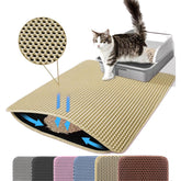 Alfombra Petinstinct extra grande frente a la caja captura migas y mantiene el suelo limpio.