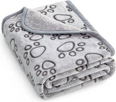 Manta Stuffed para perros con huellas gris, protege muebles y ofrece abrigo suave.