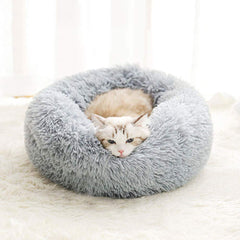 Cama Bodiseint para gato dormido en cojín redondo.