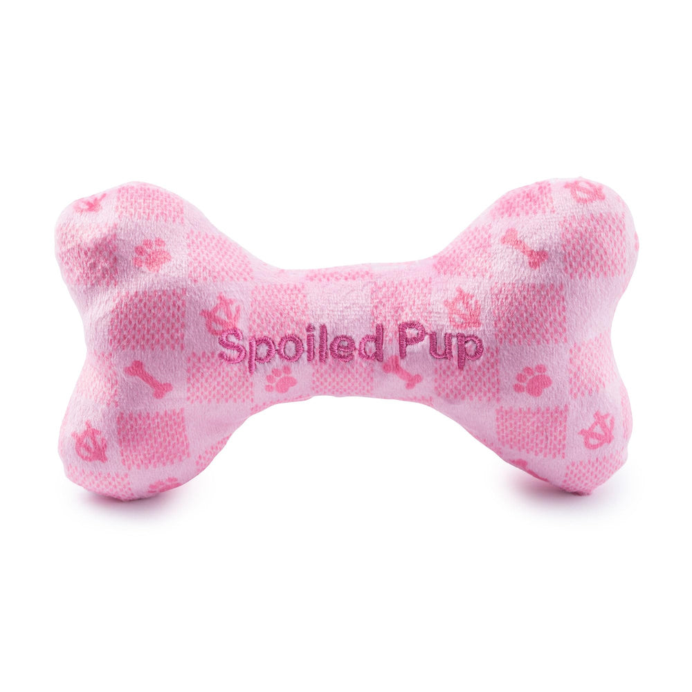 Hueso rosa a cuadros en peluche, textura suave para juego interactivo.